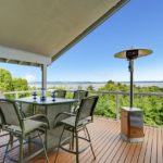 Patio-area-with-table-chairs-and-heater-on-walkout-deck-overlooking-scenic-view